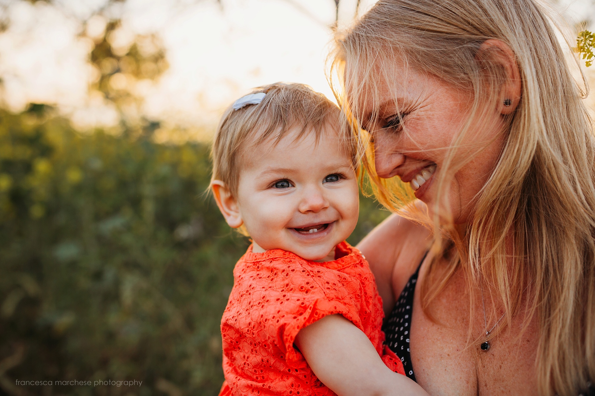 Francesca Marchese Photography mommy and little baby daughter flower field cuddles during family photography session in orange county
