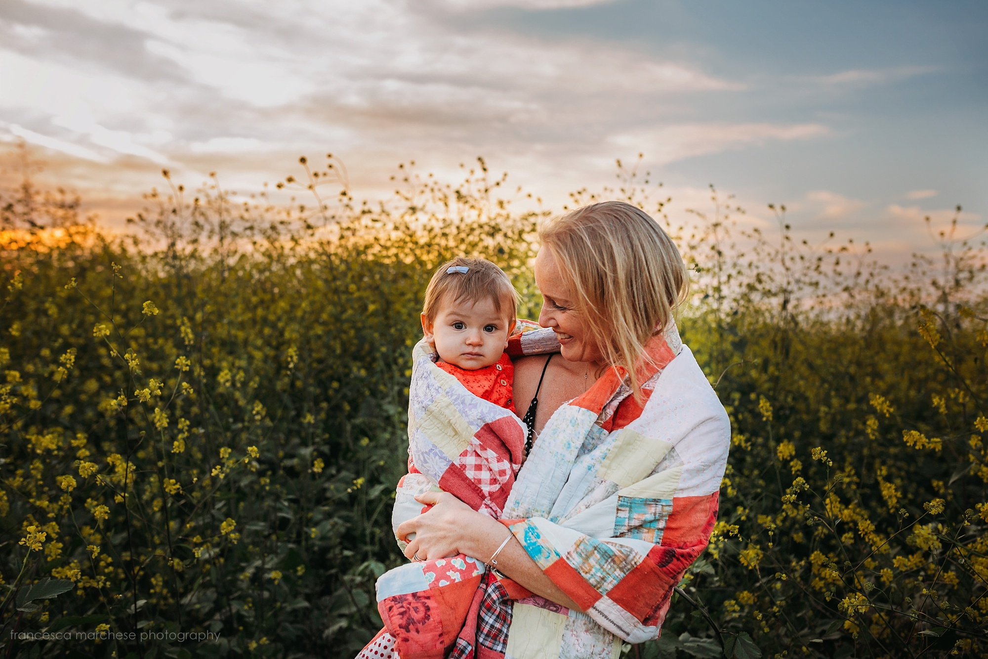 Francesca Marchese Photography mommy and little baby girl flower field cuddles during family photography session in orange county
