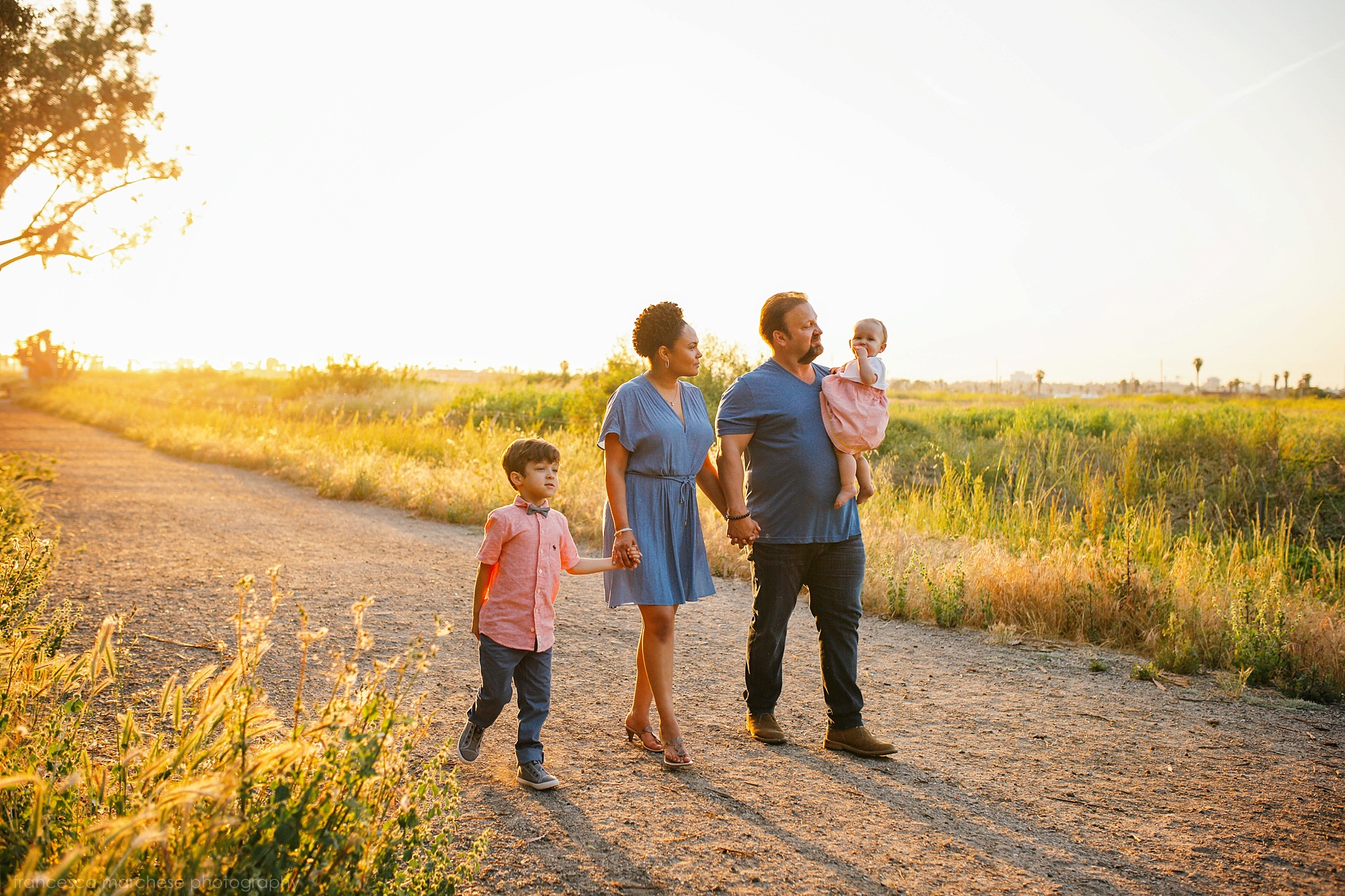 family of four walking at sunset during their family photography session in Orange County Francesca Marchese Photography
