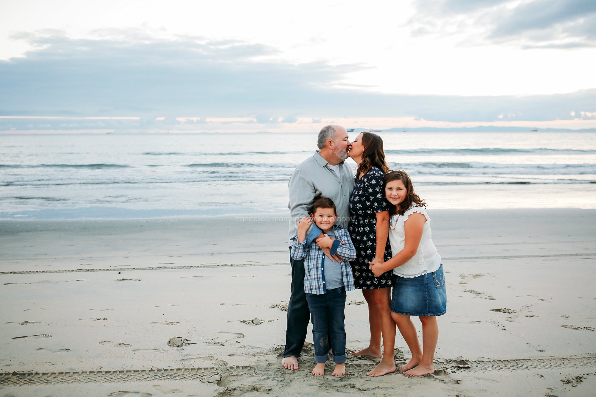 Francesca Marchese Photography family photographer sunset beach session - Orange County, Los Angeles and Long Beach area photographer family of four parents kissing